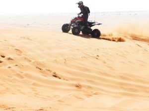 QUADBIKING IN DUBAI OPEN DESERT, SANDBOARDING, CAMEL RIDE,  BARBEQUE, 03 LIVE SHOWS AT MAJILIS CAMP